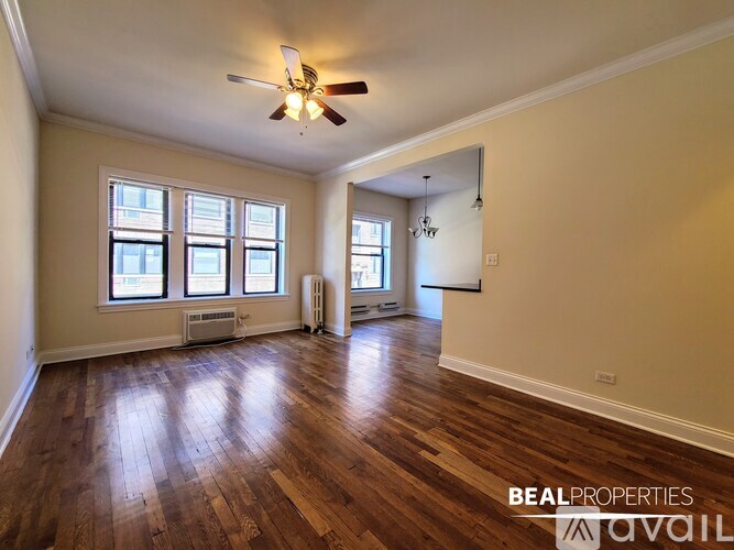 A BEALPROPERTIES sign is on the wall of a small, empty room.