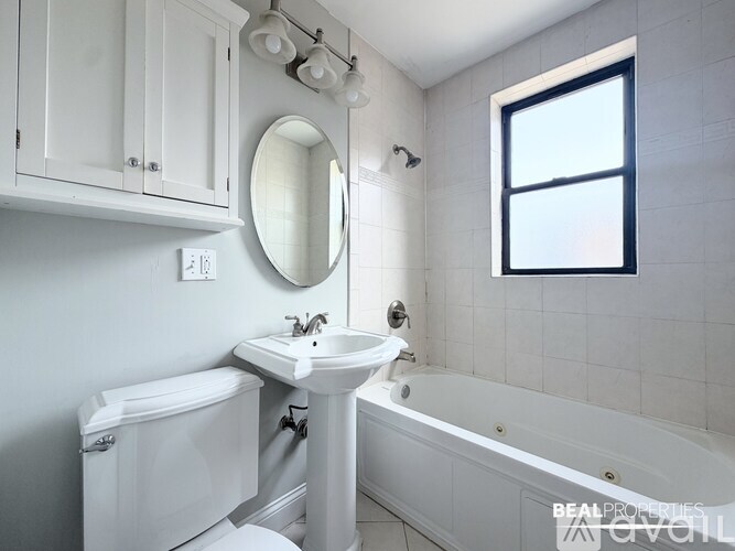 A spacious room with wooden floors and white walls.