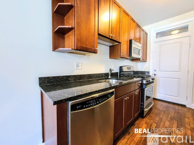 A kitchen with wooden cabinets and stainless steel appliances.