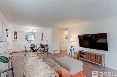 A living room with a large couch and a television.