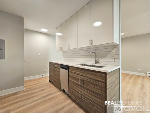 A modern kitchen with wooden cabinets and a white countertop.