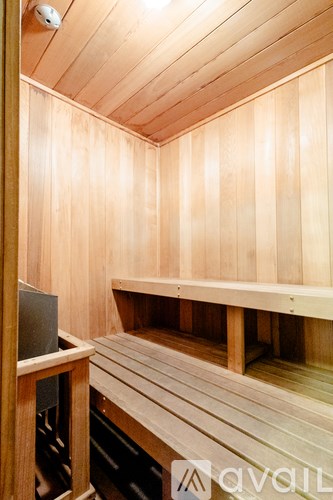 A wooden sauna with benches and a door.