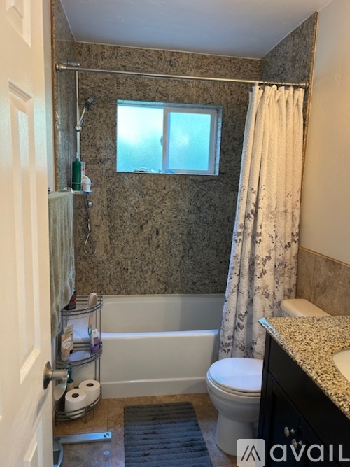 A bathroom with a toilet, sink, and bathtub.
