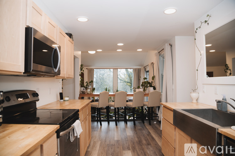 A kitchen with wooden cabinets and a black stove top oven.