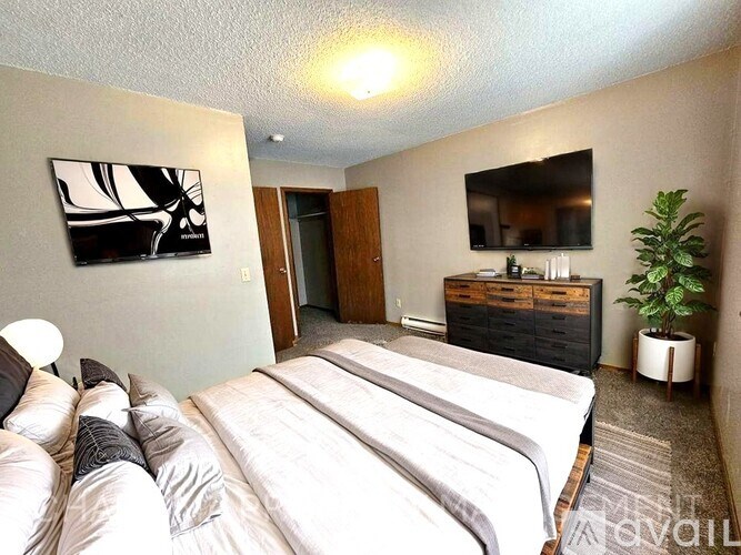 A bedroom with two beds and a dresser.