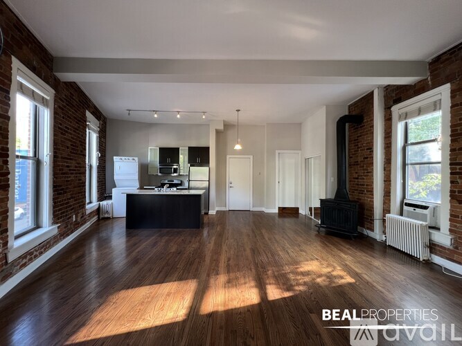 A kitchen with dark wood cabinets and a white countertop.