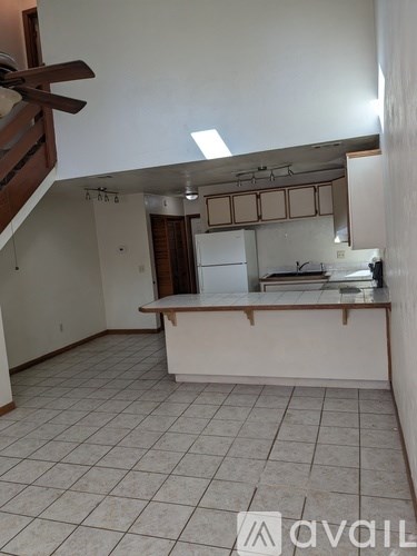 A kitchen area with a counter and a stove top oven.