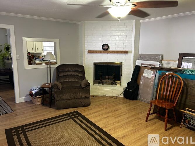 A living room with a fireplace and a chair.