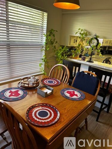 A wooden table with red and blue plates on it.