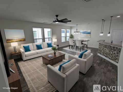 A living room with a white couch and a ceiling fan.
