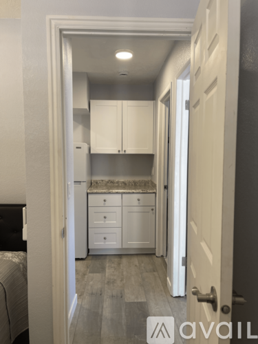 A small kitchen with white cabinets and a countertop.