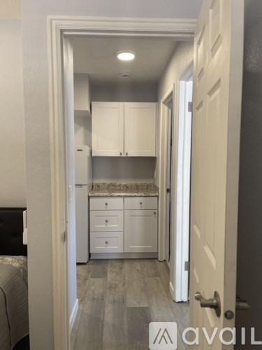 A small kitchen with white cabinets and a countertop.