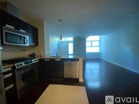 A kitchen with black cabinets and stainless steel appliances.
