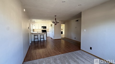 A living room with a dining table and chairs.