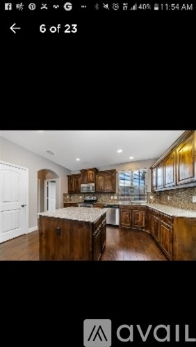 A kitchen with wooden cabinets and a marble countertop.