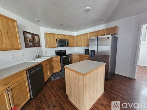 A kitchen with wooden cabinets and a white countertop.