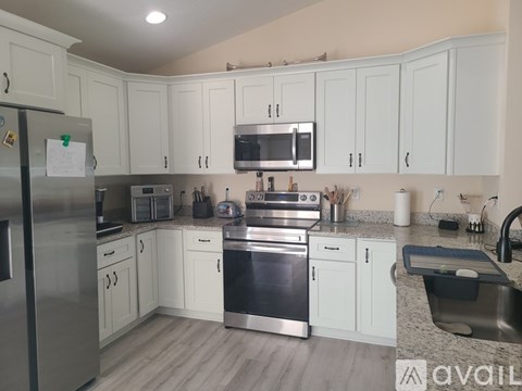 A kitchen with white cabinets and stainless steel appliances.