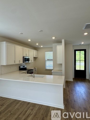 A kitchen with white cabinets and a countertop.