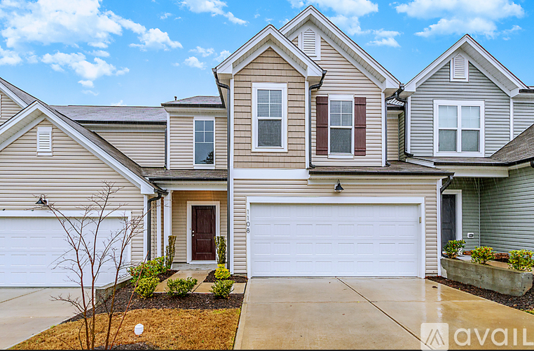 A house with a brown door and a white garage door.