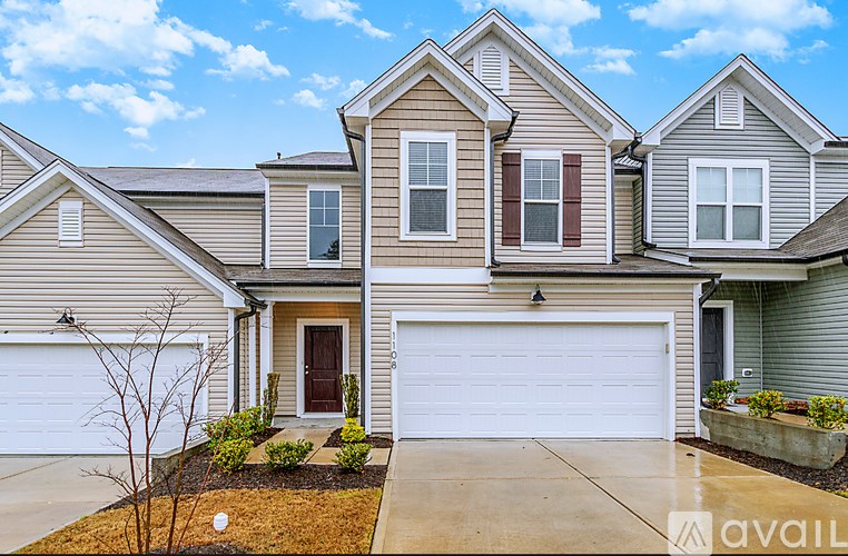 A house with a brown door and a white garage door.