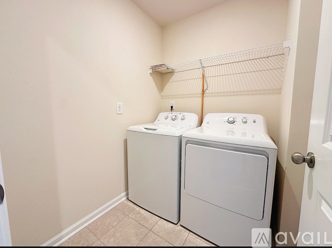 A small laundry room with a washer and dryer.