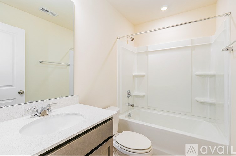 A white bathroom with a sink, toilet and bathtub.