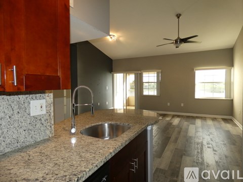 A kitchen with a sink and a fan.