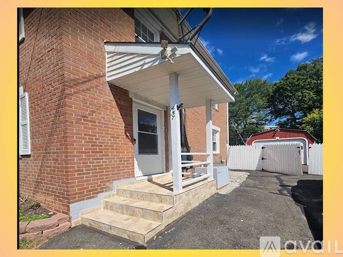 A house with a white door and steps leading to it.