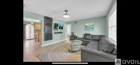 A living room with a grey couch and a coffee table.