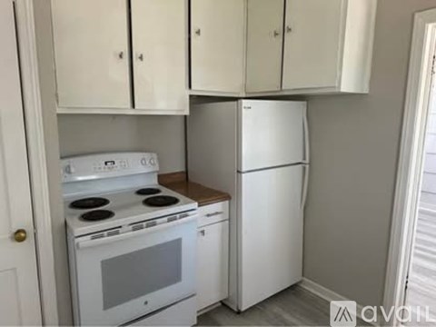 A white stove and refrigerator in a kitchen.