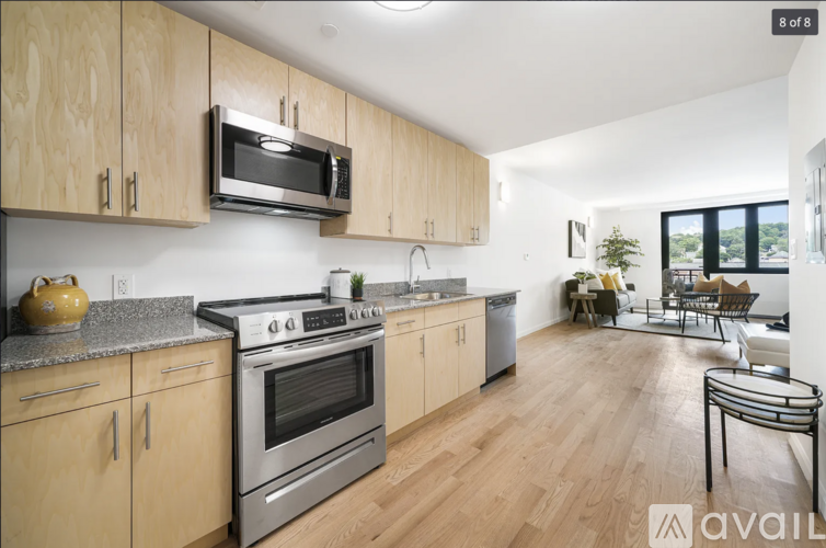 A kitchen with wooden cabinets and a stainless steel oven.