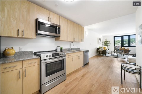 A kitchen with wooden cabinets and a stainless steel oven.