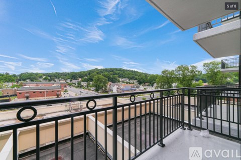 A balcony with a view of a town and buildings.