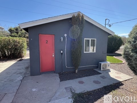 A small house with a red door numbered 2.