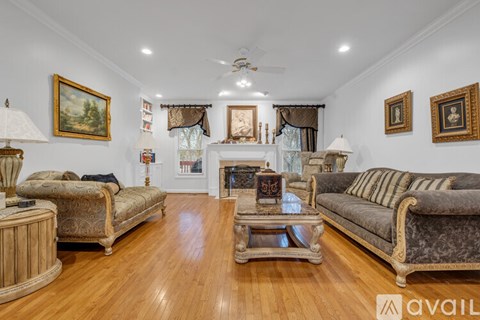 A living room with a fireplace and a painting on the wall.