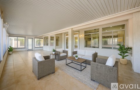 A spacious living room with a long couch and a coffee table.