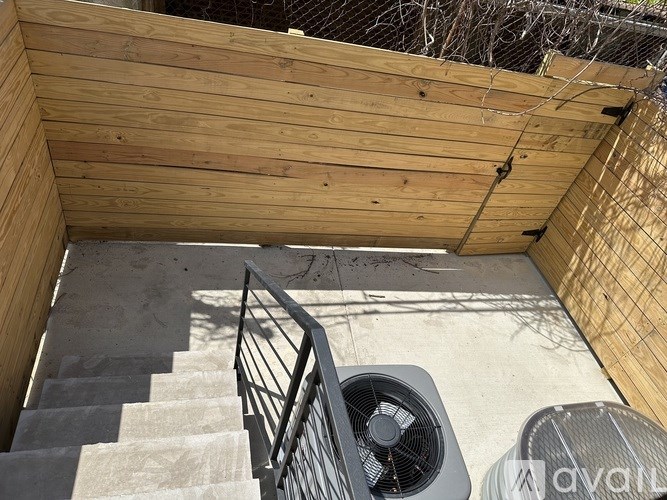 A wooden deck with a staircase and a fan.