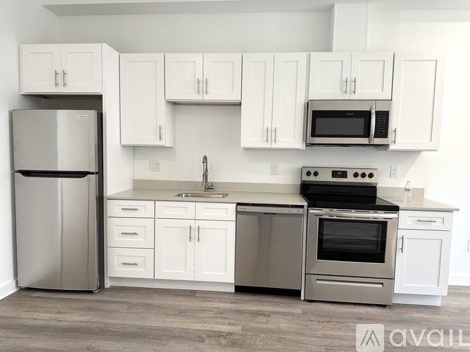 A kitchen with white cabinets and stainless steel appliances.