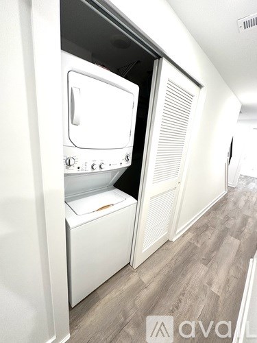 A white dishwasher is open in a kitchen.