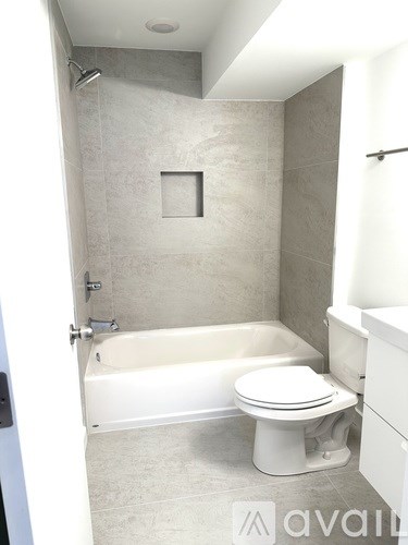 A bathroom with a toilet, tub, and sink.