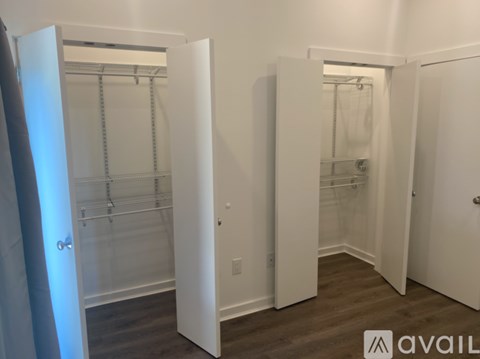 A white walk-in closet with shelves and a door.