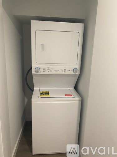 A white washing machine in a small space.