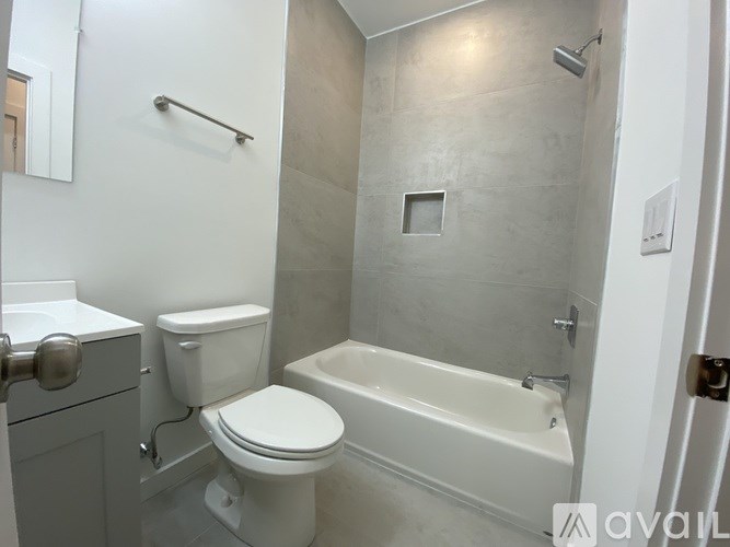 A white toilet and sink in a bathroom.