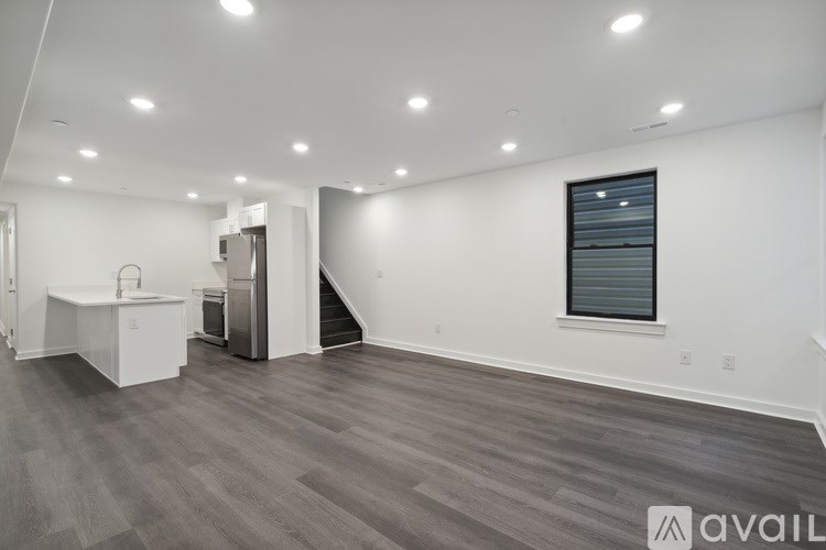 A spacious room with a grey floor and white walls.