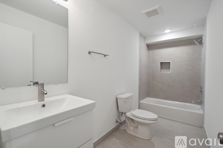 A white bathroom with a sink, toilet, and bathtub.