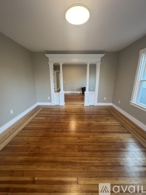 A room with wooden floors and white walls.
