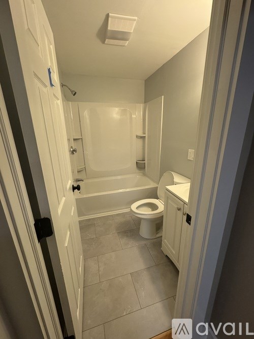 A bathroom with a toilet, sink, and bathtub.