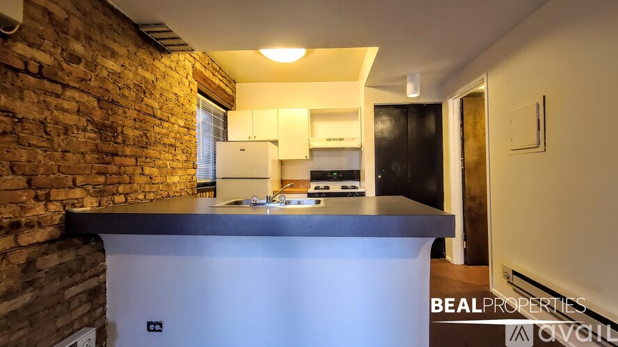 A kitchen with a brick wall and a countertop.