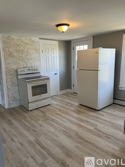 A kitchen with a white fridge and a white oven.