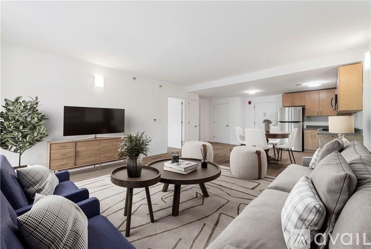 A living room with a grey couch and a wooden coffee table.